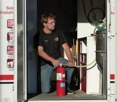 E-Z Buy Fire Supply technician with fire extinguisher